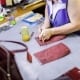 woman sewing bags